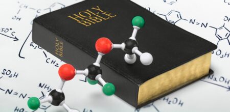 Holy bible and chemistry form, close-up view