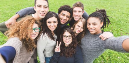 Multiethnic Group of Friends Taking Selfie at Park (iStock/william87)