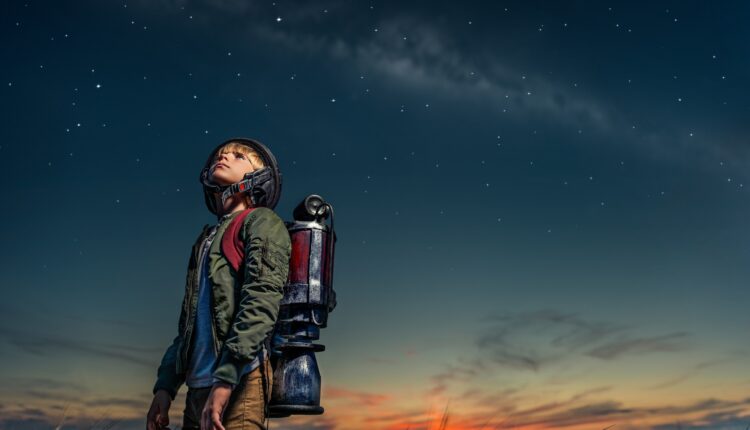 Boy with a backpack at night